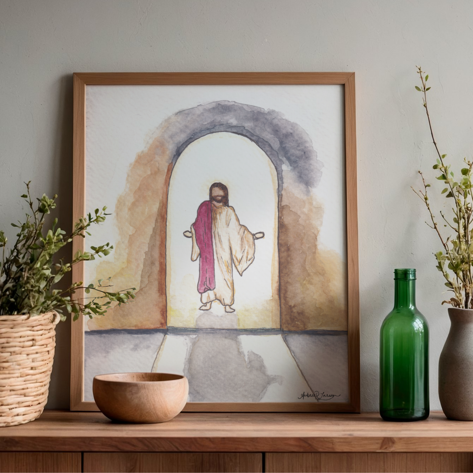 Painting of a Resurrected Jesus in a wood frame displayed on a table with decor